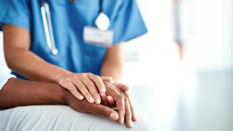 nurse holding a patients hand