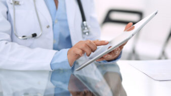 doctor working on a tablet device