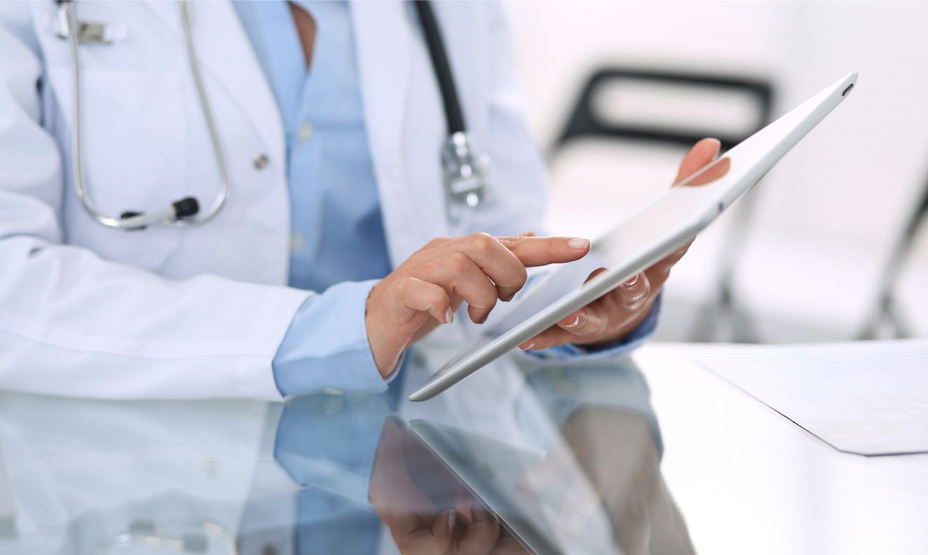 doctor working on a tablet device