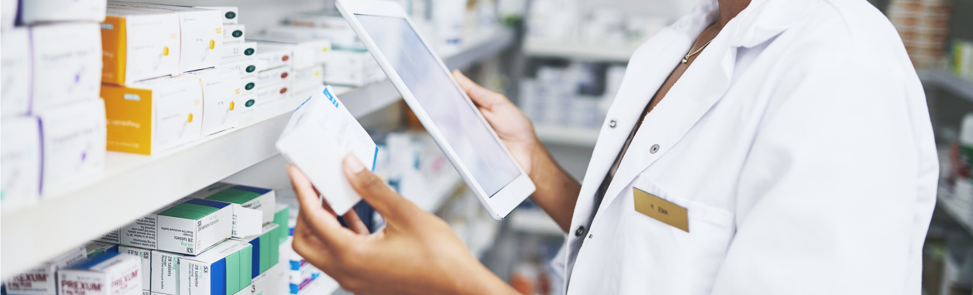 pharmacist checking prescription information on a tablet device