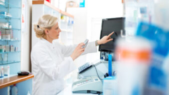pharmacist looking at drug information on a computer