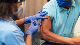 nurse administering a COVID-10 vaccine