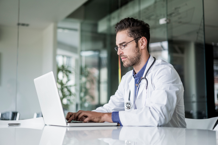 male doctor working on a laptop