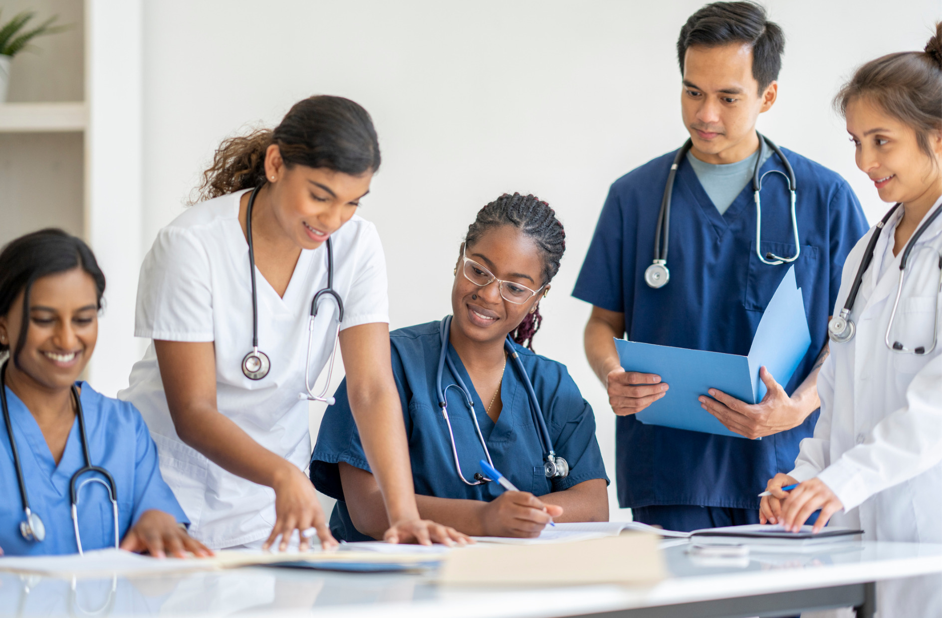 small group of medical students sitting around a table as they study together