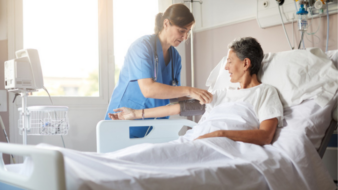hospital nurse taking care of a patient in bed