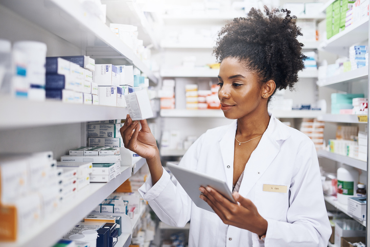 pharmacist teaching how to check medication while holding a tablet device