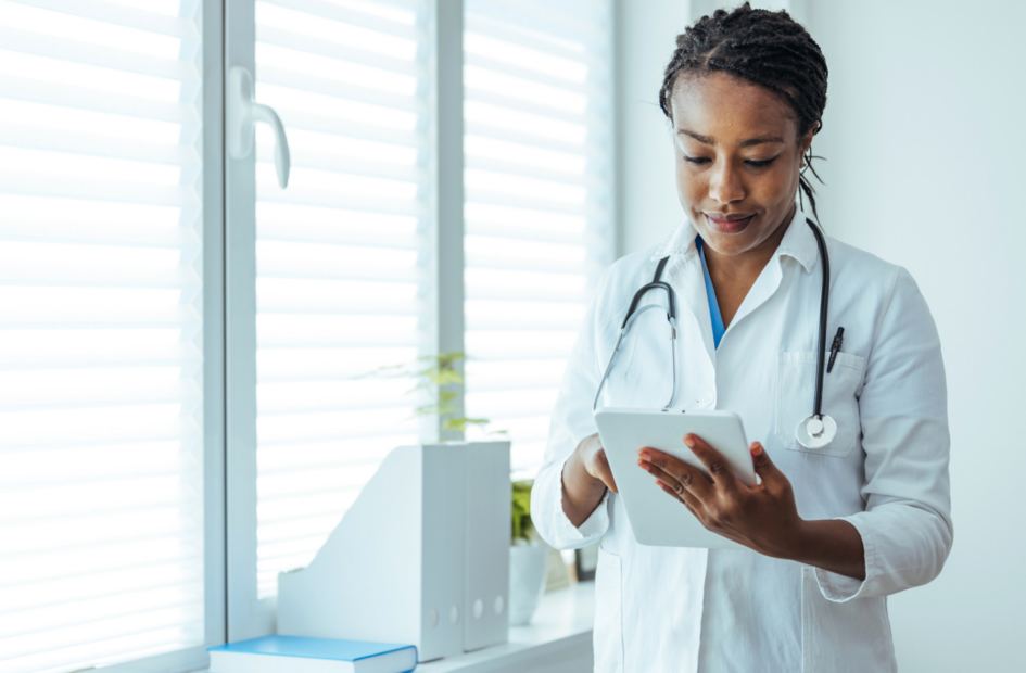 physician looking at a tablet device in her office