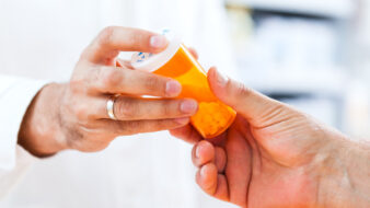 pharmacist giving prescription to a patient