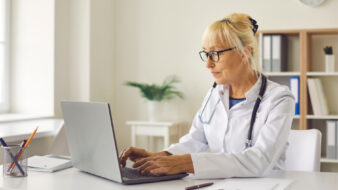 doctoring working on a laptop