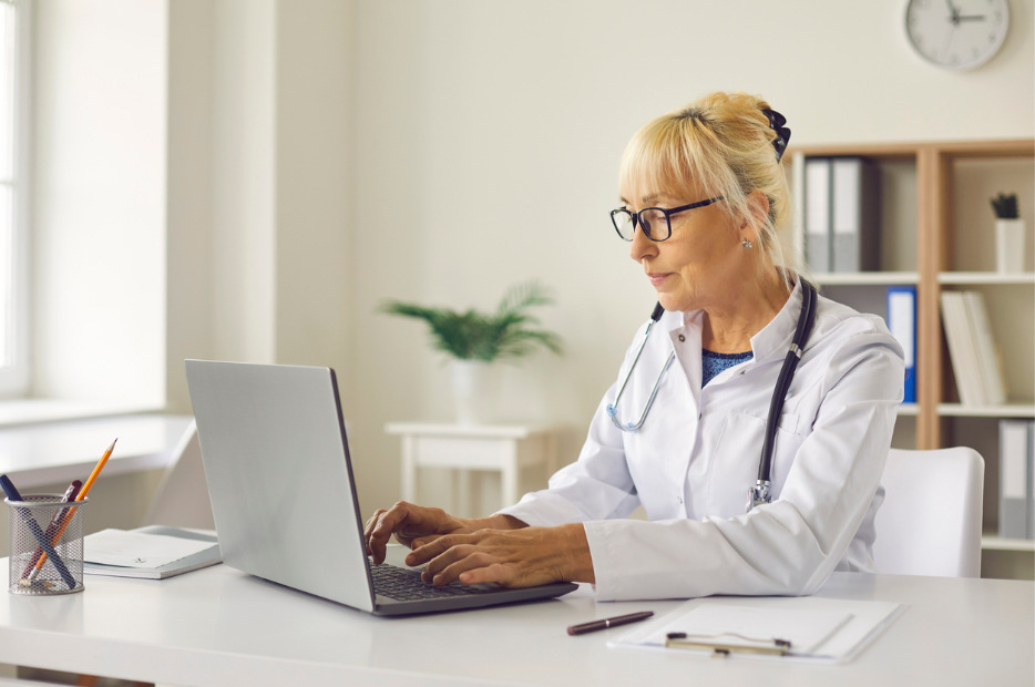 doctoring working on a laptop