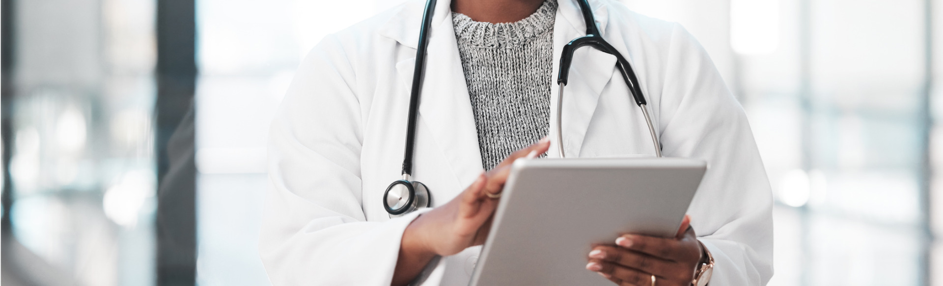 physician assistant working on a tablet device at work