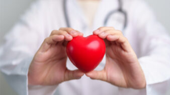doctor holding a red heart
