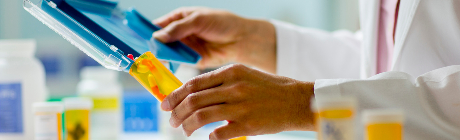 pharmacy student putting counted pills in a prescription bottle