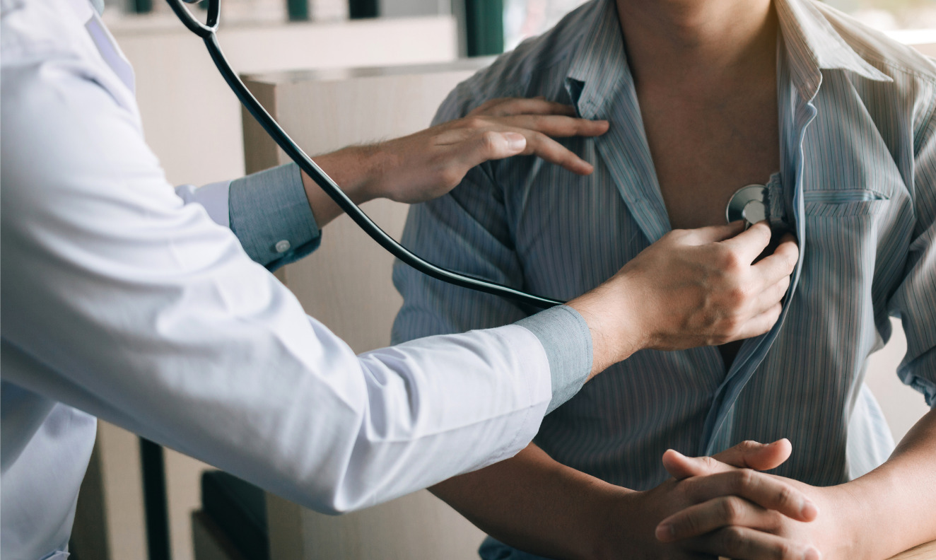 doctor listening to a male patient's heart with a stethoscope