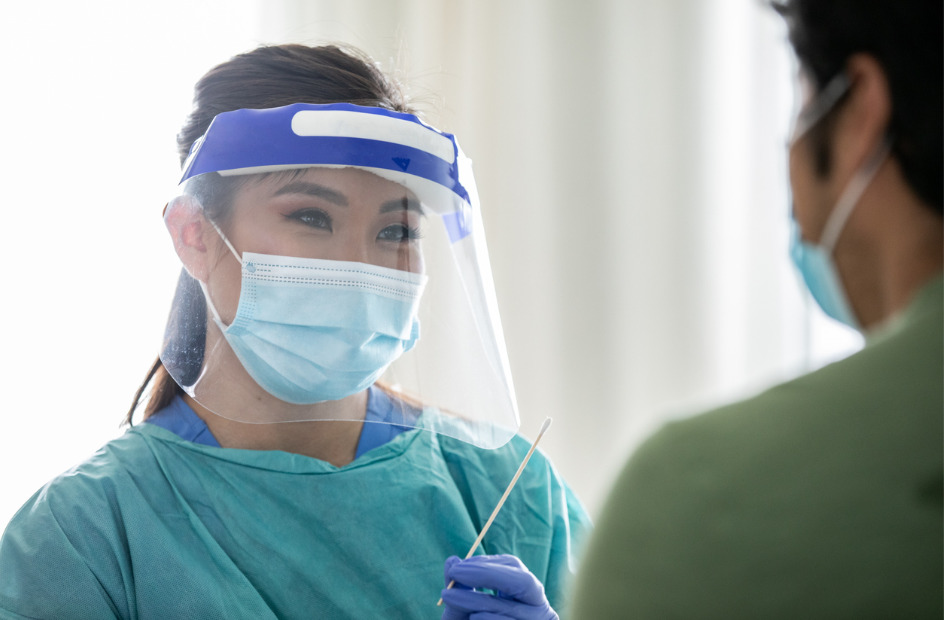 pharmacy technician wearing a mask and shield