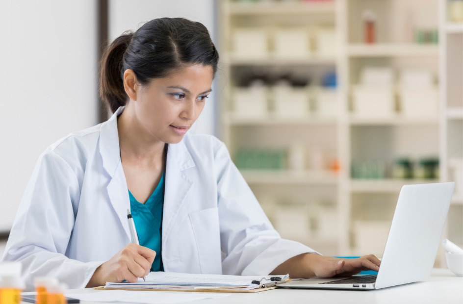 pharmacy technician working on their laptop