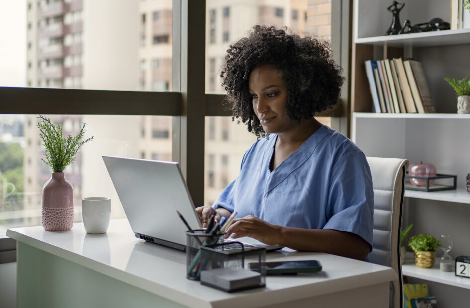 female nurse working on laptop