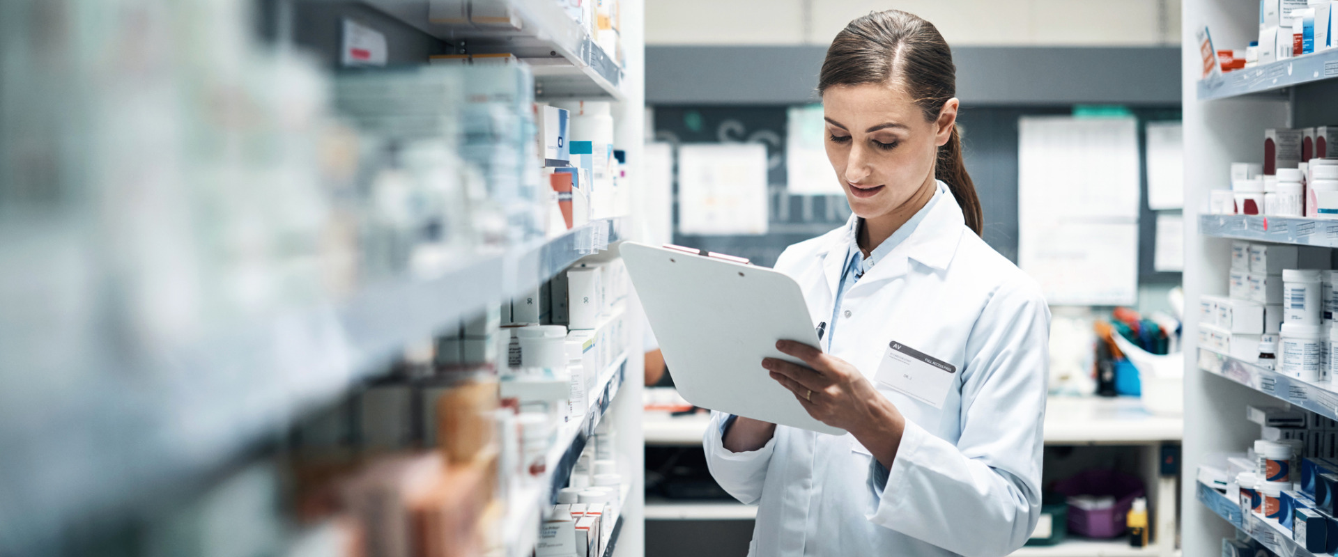 pharmacist checking pharmacy laws in the stock room