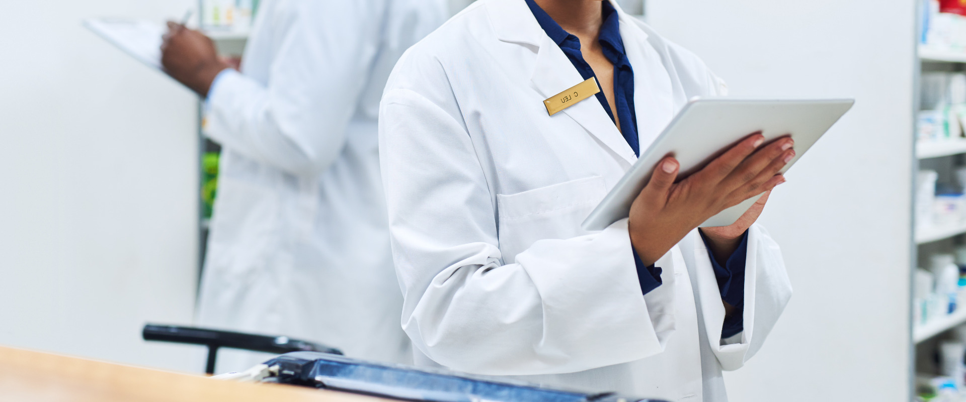 pharmacist looking at pharmacy laws database on a tablet device