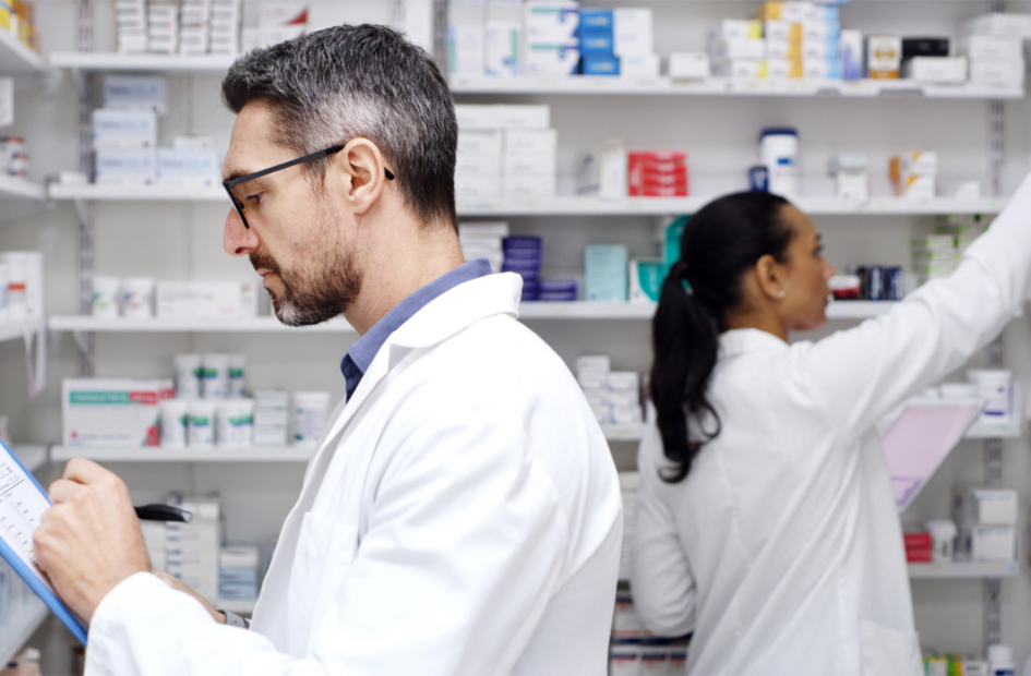 two retail pharmacists checking stock
