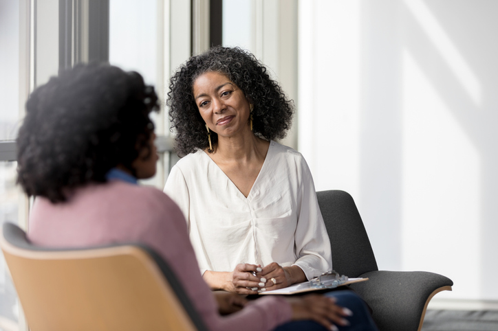 counselor talking with a patient in her office