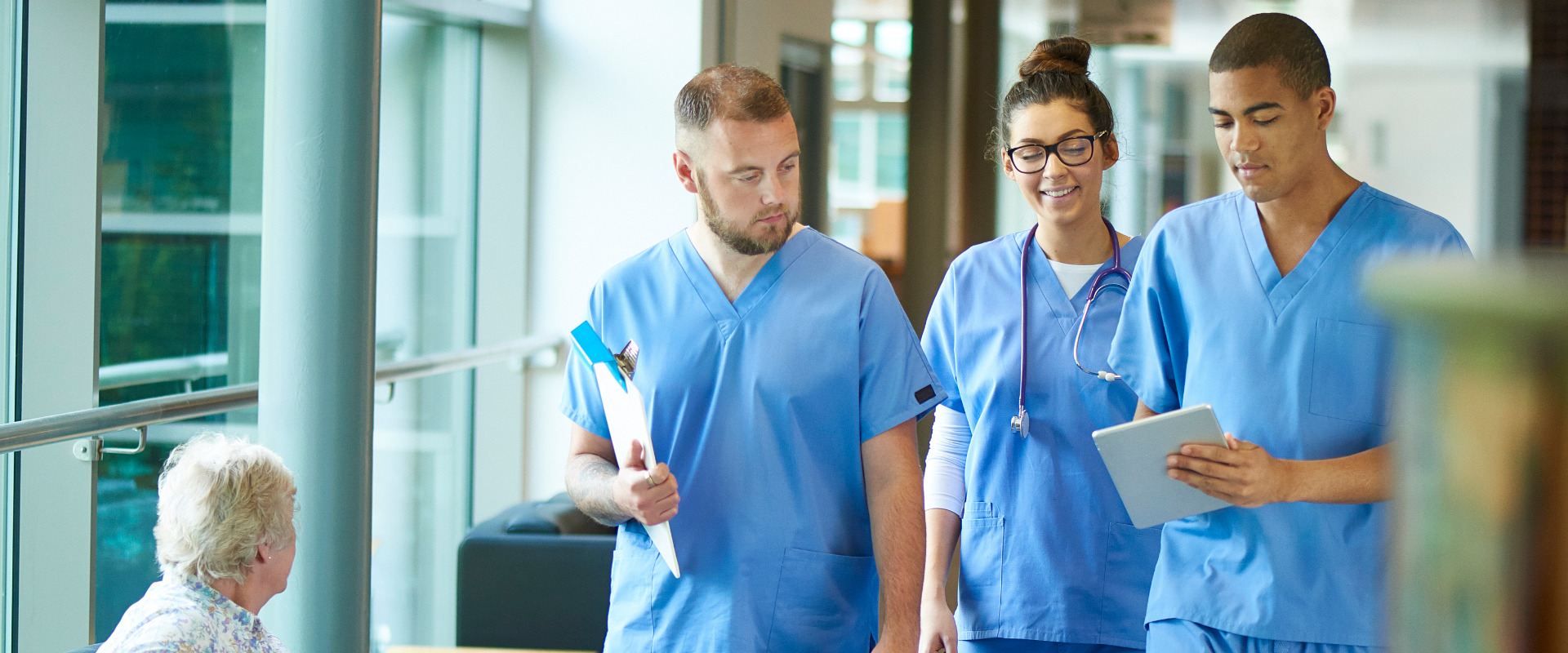 a group of nurses walking through a hospital