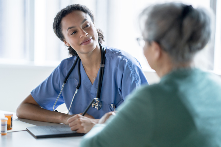 nurse speaking with a patient about med management