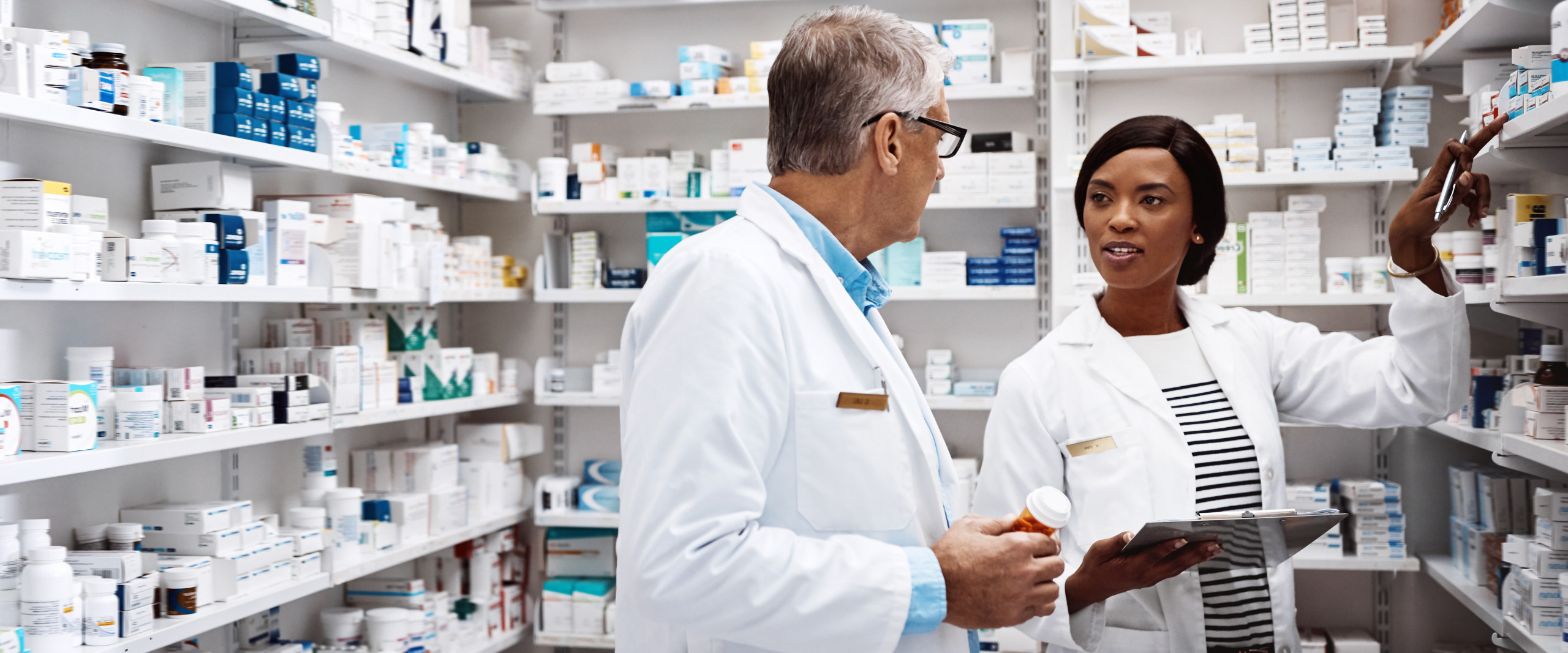 two pharmacists in the pharmacy stock room