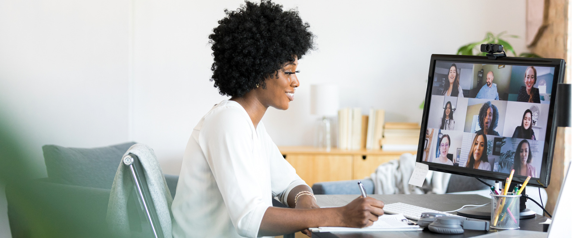 woman working at desk on a virtual meeting