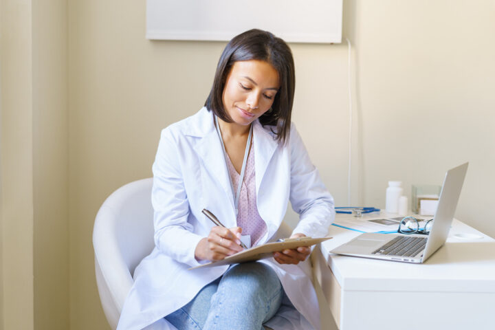 Nurse practitioner completing patient form