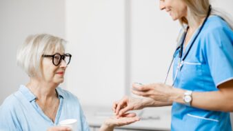 Nurse practitioner giving medication to patient