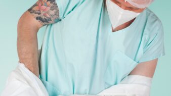 pharmacy tech with tattoos gowning