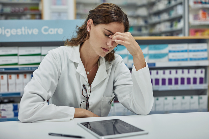 female pharmacist looking stressed